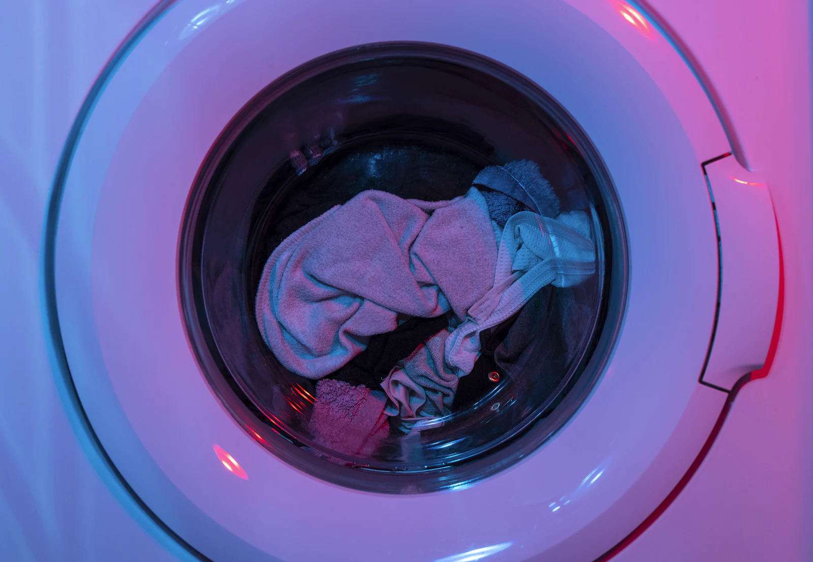 Freshly washed laundry in a lit washing machine